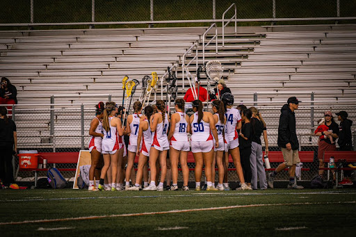 Centennial’s girl’s lacrosse team huddles during a game against Howard on April 24