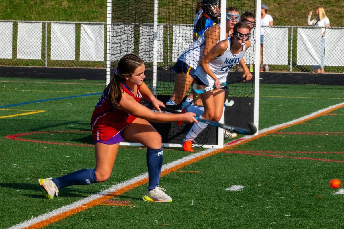Caption: Freshman JV field hockey player Emi McManus takes a corner. 
Photo provided by: Cheryl Cudzilo
