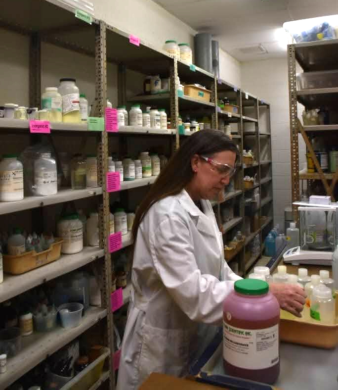 Centennial Science Paraeducator Jessica Stockham prepares a lab.